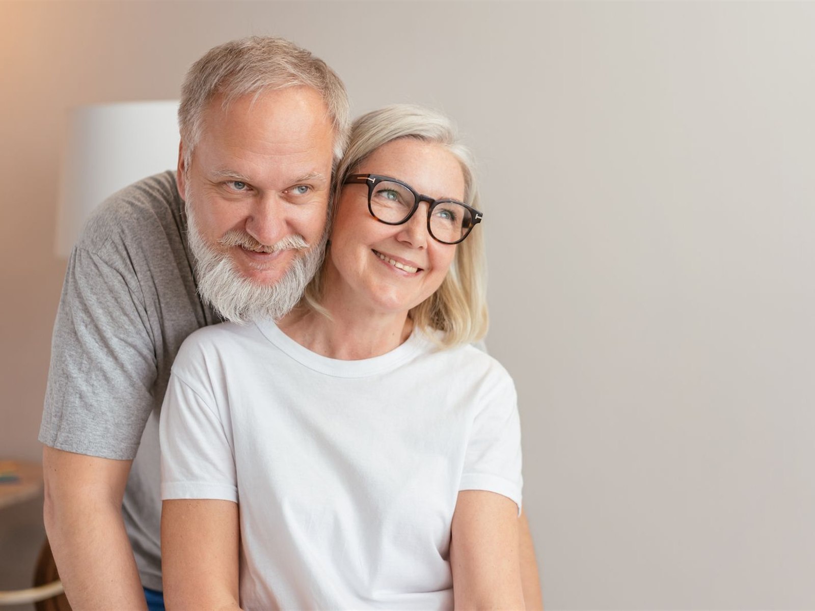 A happy couple embracing at home